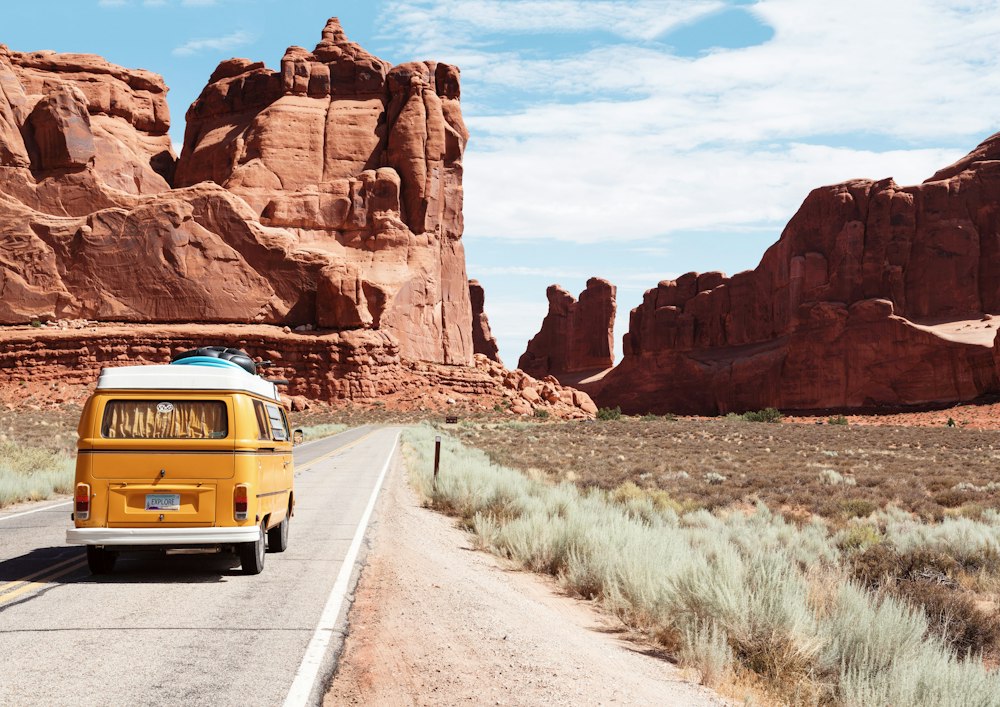 Travellers on a scenic road trip through red rock canyons